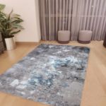 Modern abstract area rug with a blend of soft gray and baby blue patterns, showcasing intricate designs, perfect for enhancing living room decor with a contemporary touch.