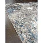 Modern abstract area rug with a blend of soft gray and baby blue patterns, showcasing intricate designs, perfect for enhancing living room decor with a contemporary touch.