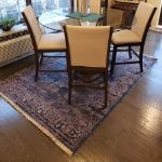 Practical Rug with Distressed Blue Medallion Design. Blue Rug under a dining table.