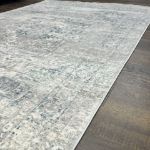 Elegant vintage light gray area rug with a soft short polyester pile perfect for traditional and modern interiors