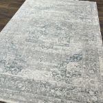 Sophisticated vintage-style area rug with light gray medallion pattern and soft pile for home decor