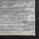 Modern Smyrna rug featuring delicate patterns and muted gray, silver, and white shades for sophisticated aesthetics