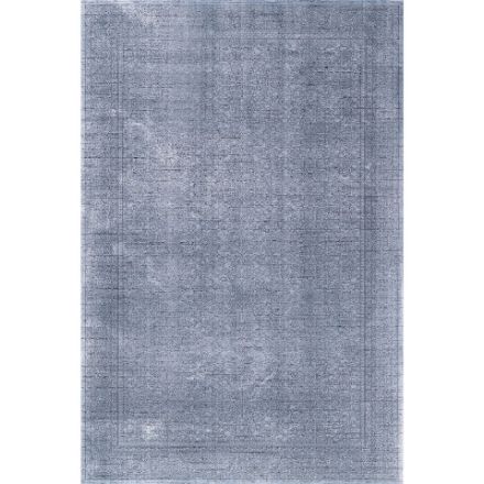 Smyrna Blue Dream Vintage Rug with Intricate Persian-Inspired Patterns and Fringed Edges on Dark Hardwood Floor