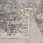 Elegant Smyrna rug featuring a flowing, textured design with muted gold and grayish blue highlights