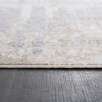 Faded and textured Smyrna rug with gold and grayish blue accents, perfect for modern and classic interiors