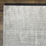 Soft and cozy silver gray striped Mystique rug with subtle texture and fringe details.