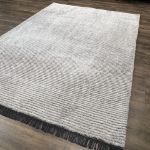 Premium silver gray striped rug offering plush comfort and modern style with tassel fringe.