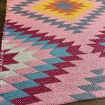 Turkish kilim area rug with bold pink and colorful tribal geometric motifs