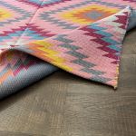 Lightweight Turkish flatweave rug with colorful geometric patterns for industrial or eclectic spaces