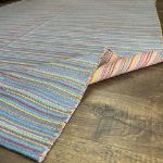 Blue and pink Turkish kilim rug with bold striped details for cozy and modern interiors